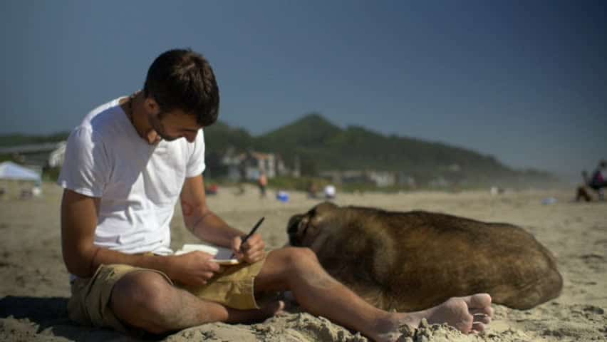 guy writing in sand